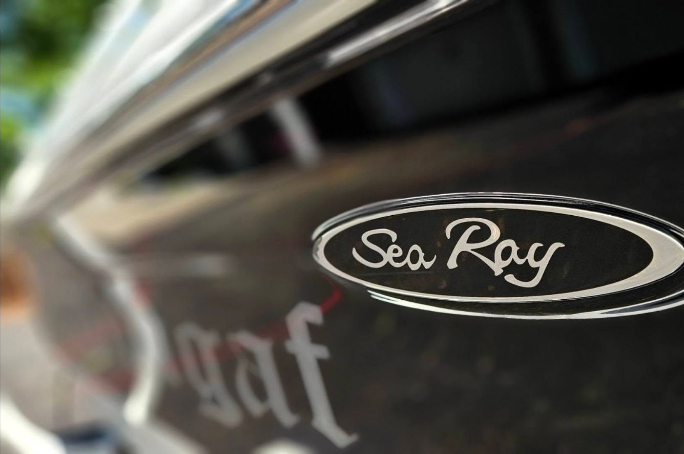 Sea Ray emblem close-up on polished black hull