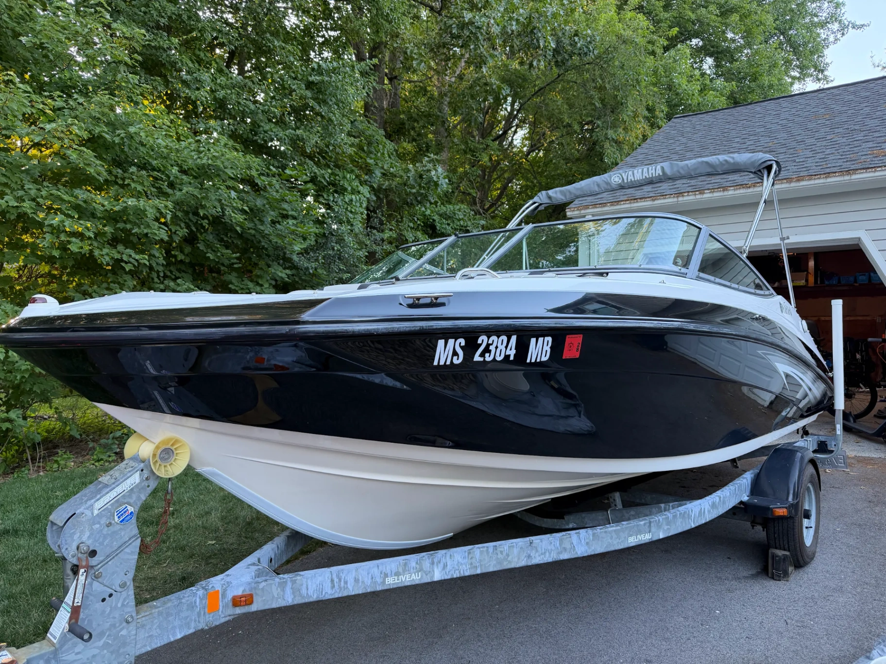 Yamaha jet boat with mirror black hull detailed on trailer